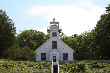 Old Mission Peninsula Lighthouse front view with stairs from beach